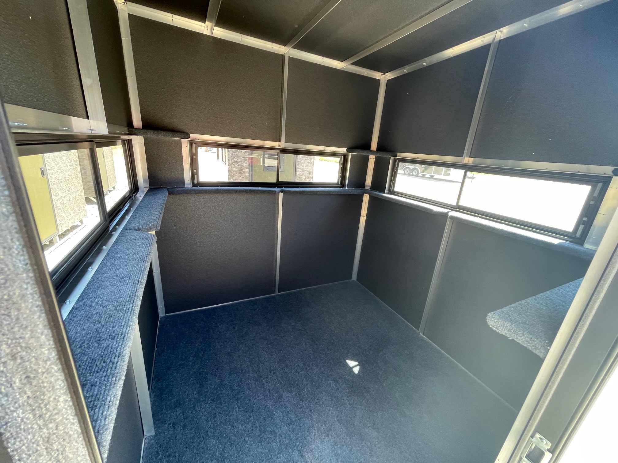 Deer blind interior with carpet and windows